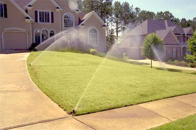 sprinklers running at full blast on an Aurora lawn